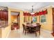 Bright dining area with decorative window treatments, adjacent to an open-concept kitchen at 755 Country Charm Cir, Oviedo, FL 32765