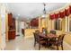 Bright dining area features a charming chandelier and table with seating for four at 755 Country Charm Cir, Oviedo, FL 32765