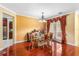 Elegant dining room featuring hardwood floors, a chandelier, and bright natural light from the adjacent window at 755 Country Charm Cir, Oviedo, FL 32765