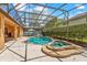 Beautiful screened-in pool and spa area with lush greenery offering a private oasis for relaxation and entertainment at 755 Country Charm Cir, Oviedo, FL 32765