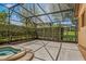 Partial view of a screened-in pool area featuring a spa and lush landscaping, creating a private outdoor retreat at 755 Country Charm Cir, Oviedo, FL 32765