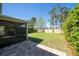 A fenced-in backyard features a covered patio with brick pavers and a well-maintained lawn at 8066 Bowery Dr, Winter Garden, FL 34787