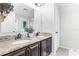 Bathroom featuring granite countertops, double sinks, updated faucets, and shower with glass door at 8066 Bowery Dr, Winter Garden, FL 34787