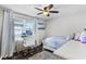 Bedroom with wood-look floors, white curtains, and a ceiling fan at 8066 Bowery Dr, Winter Garden, FL 34787