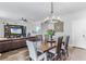 Elegant dining room with hardwood floors, decorative chandelier, and comfortable seating for memorable meals at 8066 Bowery Dr, Winter Garden, FL 34787