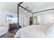 Spacious main bedroom featuring wood-look floors, a TV, a walk-in closet, and ensuite bathroom at 8066 Bowery Dr, Winter Garden, FL 34787