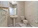 Half bathroom with pedestal sink, tile floors, and floral wallpaper at 9400 Southern Garden Cir, Altamonte Springs, FL 32714