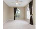 Bedroom featuring neutral walls, carpet, and arched windows for soft natural light at 9400 Southern Garden Cir, Altamonte Springs, FL 32714