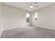 Neutral bedroom showcasing plush carpeting, a ceiling fan, and natural light from two windows at 9400 Southern Garden Cir, Altamonte Springs, FL 32714