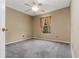 Neutral bedroom featuring plush carpeting, a ceiling fan, and natural light from the window at 9400 Southern Garden Cir, Altamonte Springs, FL 32714