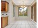 Breakfast nook with tiled flooring, a chandelier and bright windows with views of the backyard at 9400 Southern Garden Cir, Altamonte Springs, FL 32714