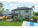 Exterior view of a home featuring a pergola, lush greenery, and a greenhouse at 9400 Southern Garden Cir, Altamonte Springs, FL 32714