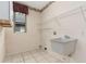 Laundry room featuring tile floors, a utility sink, and overhead shelving at 9400 Southern Garden Cir, Altamonte Springs, FL 32714