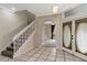 Inviting foyer featuring tiled floors, an arched entrance, staircase, and entry to the living area at 9400 Southern Garden Cir, Altamonte Springs, FL 32714