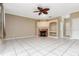 Bright living room features tile flooring, a ceiling fan, fireplace, and a built-in shelving unit at 9400 Southern Garden Cir, Altamonte Springs, FL 32714