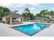 Community pool with a covered seating area, lounge chairs and well maintained pool deck at 9400 Southern Garden Cir, Altamonte Springs, FL 32714