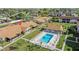 Aerial view of the community pool with lounge chairs, and nearby single-story homes with landscaped yards at 1001 Plantation Dr # D5, Kissimmee, FL 34741
