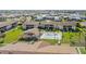 Sprawling aerial view showcases a well maintained community with pool, palm trees and lush green lawns at 1001 Plantation Dr # D5, Kissimmee, FL 34741