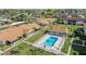 Aerial view of the community pool with lounge chairs, and nearby single-story homes with landscaped yards at 1001 Plantation Dr # D5, Kissimmee, FL 34741
