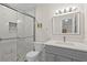 Bathroom with glass shower, white marble tile and grey vanity at 1001 Plantation Dr # D5, Kissimmee, FL 34741