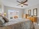 Bedroom with light walls, ceiling fan, and large windows at 1001 Plantation Dr # D5, Kissimmee, FL 34741