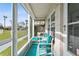 Inviting screened-in porch with seating and a view of a palm-lined street at 1001 Plantation Dr # D5, Kissimmee, FL 34741