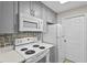 Kitchen with white appliances, ample counter space, and tiled backsplash at 1001 Plantation Dr # D5, Kissimmee, FL 34741