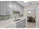 Bright kitchen with grey cabinets and stone tile backsplash at 1001 Plantation Dr # D5, Kissimmee, FL 34741