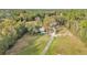 Home on a large lot with a long driveway surrounded by lush trees offering a tranquil setting at 10115 E Highway 316, Fort Mc Coy, FL 32134