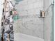 Bathroom shower featuring gray and white marble-look tile, and a black and white shower curtain at 10115 E Highway 316, Fort Mc Coy, FL 32134