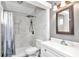 Bathroom features a shower with white marble-look tile, a rainfall showerhead, and a built-in shelf at 10115 E Highway 316, Fort Mc Coy, FL 32134
