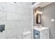 Bathroom featuring marble-look tile, a shower with a rainfall showerhead, and a vanity with storage at 10115 E Highway 316, Fort Mc Coy, FL 32134