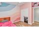 This pink bedroom features wood-look floors and a closet at 10115 E Highway 316, Fort Mc Coy, FL 32134
