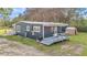 Cozy single-story home featuring a metal roof, painted exterior, and small shed on a grassy lot at 10115 E Highway 316, Fort Mc Coy, FL 32134