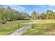 Sprawling front yard leading to a single-story home with a long driveway and ample parking at 10115 E Highway 316, Fort Mc Coy, FL 32134