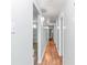 Hallway features wood floors, light gray paint, and doors leading to the home's rooms at 10115 E Highway 316, Fort Mc Coy, FL 32134