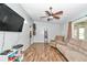 A cozy living room with hardwood floors, a ceiling fan, and comfortable seating at 10115 E Highway 316, Fort Mc Coy, FL 32134