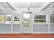 Bright sunroom with wood floor and multiple windows at 10115 E Highway 316, Fort Mc Coy, FL 32134
