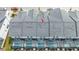 An aerial view of the roofs and rear of townhomes with screen patios and pools at 10443 Ebb Tide Ln, Orlando, FL 32821