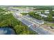 Scenic aerial view of townhome community, highlighting the prime location near lush greenery and a serene lake at 10443 Ebb Tide Ln, Orlando, FL 32821