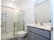 Modern bathroom with glass enclosed shower and vanity with a quartz countertop at 10443 Ebb Tide Ln, Orlando, FL 32821