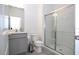 Clean and well-lit bathroom with a glass-enclosed shower, modern vanity, and neutral tile flooring at 10443 Ebb Tide Ln, Orlando, FL 32821