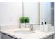 Close-up of bathroom vanity with quartz countertop, modern faucet, and decorative accessories at 10443 Ebb Tide Ln, Orlando, FL 32821