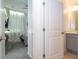 Open doorway between stylish bedroom and bathroom with updated vanity and fixtures at 10443 Ebb Tide Ln, Orlando, FL 32821
