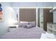 Modern bedroom features a stylish accent wall, a comfortable bed, and a spacious walk-in closet at 10443 Ebb Tide Ln, Orlando, FL 32821