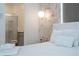 Bright bedroom featuring a marble accent wall, pendant lighting, and a modern en-suite bathroom at 10443 Ebb Tide Ln, Orlando, FL 32821