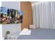 This bedroom features a gray comforter, wood accent wall, TV, and beige armchair at 10443 Ebb Tide Ln, Orlando, FL 32821