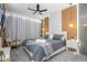 Stylish bedroom with a modern ceiling fan, accent walls, and ambient lighting at 10443 Ebb Tide Ln, Orlando, FL 32821