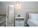 Bedroom with modern illuminated mirror, stylish nightstand, and comfortable bed with plush bedding at 10443 Ebb Tide Ln, Orlando, FL 32821