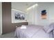 Comfortable bedroom with a decorative accent wall, TV, and soft white drapes at 10443 Ebb Tide Ln, Orlando, FL 32821
